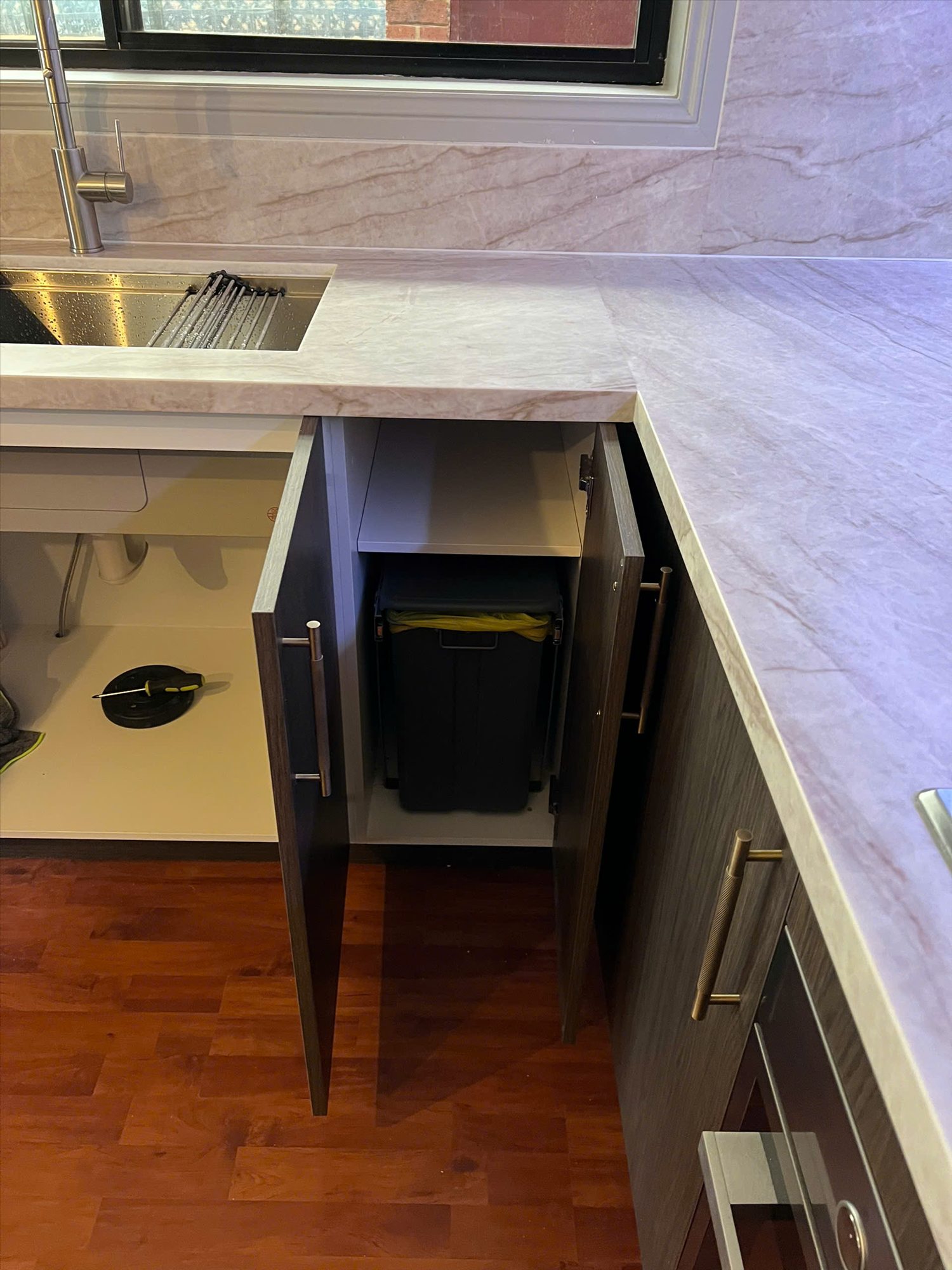 Integrated bin cabinet and stone-look benchtop detail